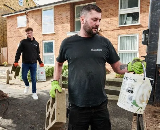 two men loading a van after a building waste clearance