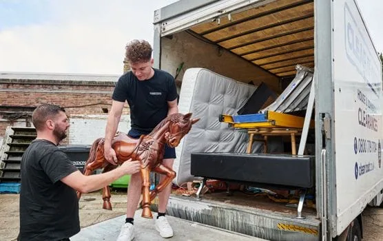 two men loading a van as part of an end of tenancy clearance