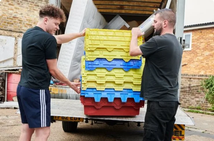 Two men loading a van as part of a Garage clearing professional service
