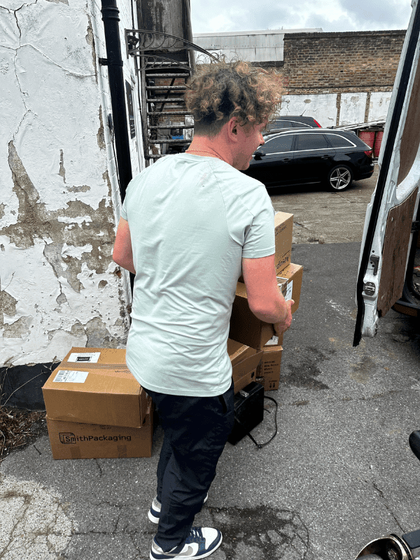 moving boxes into a van to clear then from a house