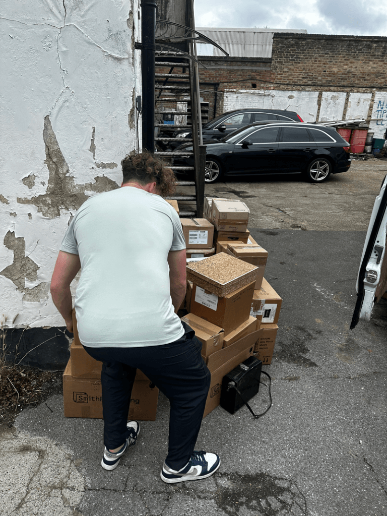 A man picking up boxes from a house clearance