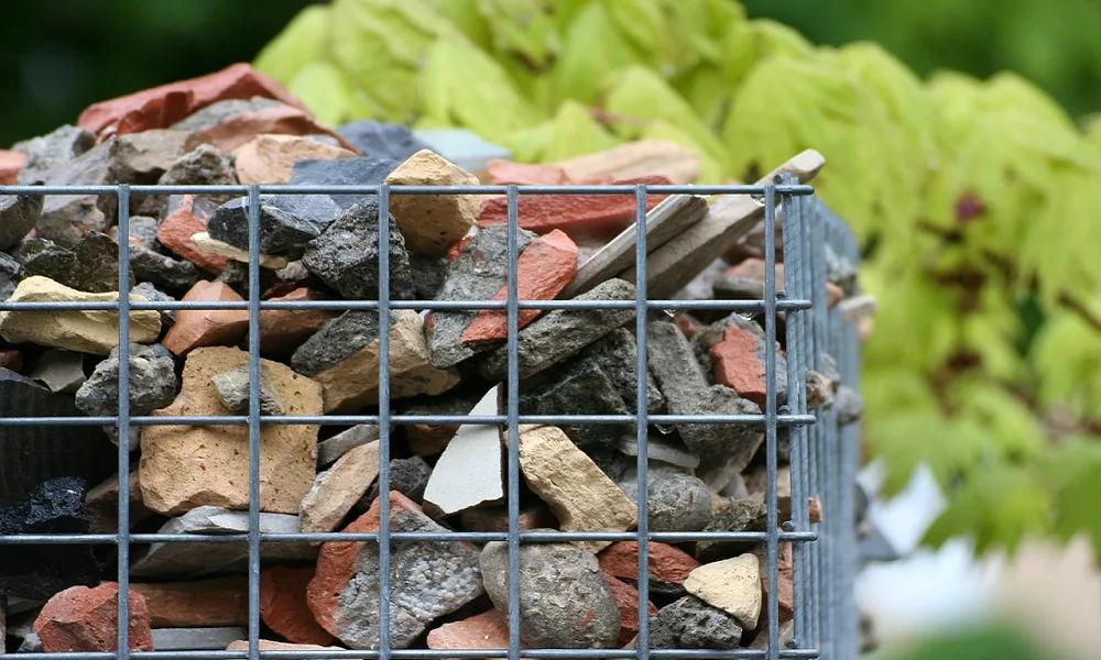 A cage holding broken ruble using sustainable waste management