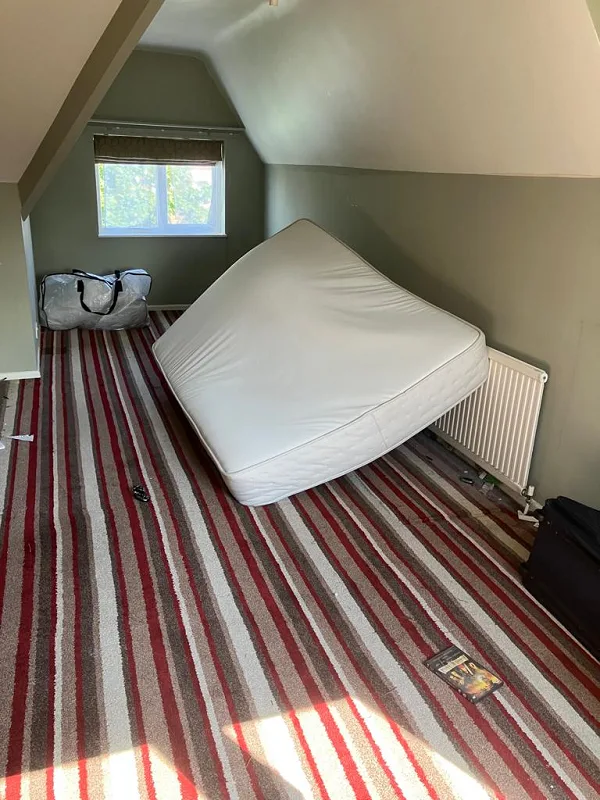 A bedroom with a mattress in that requires removing using a clearance service